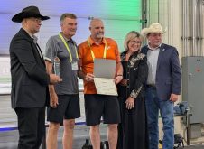PhiBer Manufacturing won the AgTech innovation award for its drone carrier at the Ag in Motion innovation program, with Saskatchewan Minister of Agriculture Daryl Harrison, right, presenting the award. Photo: Jonah Grignon