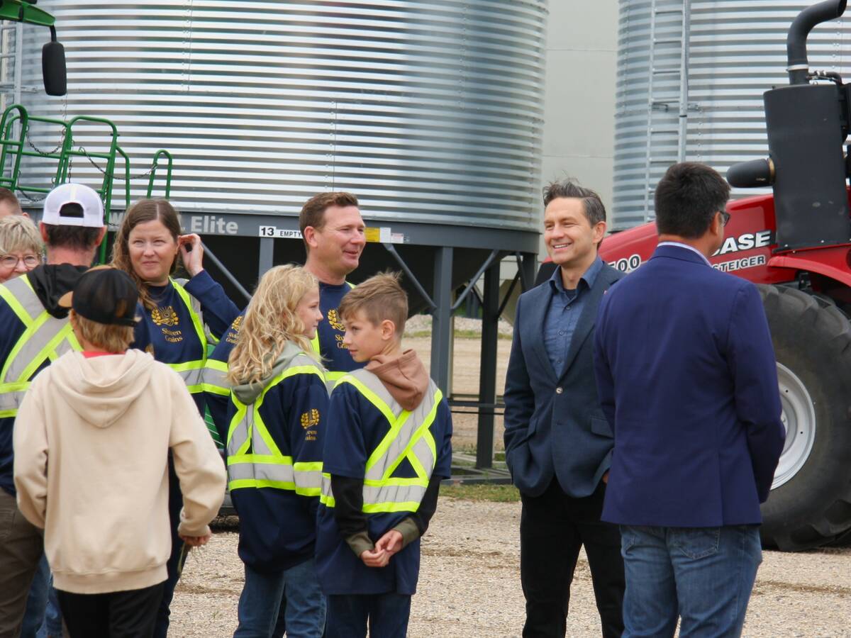 Pierre Poilievere at Sixteen Grains near Saskatoon, Sask. speaking to one of the farm owners. Photo: Janelle Rudolph