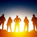 Group of five women silhouettes in sunset light