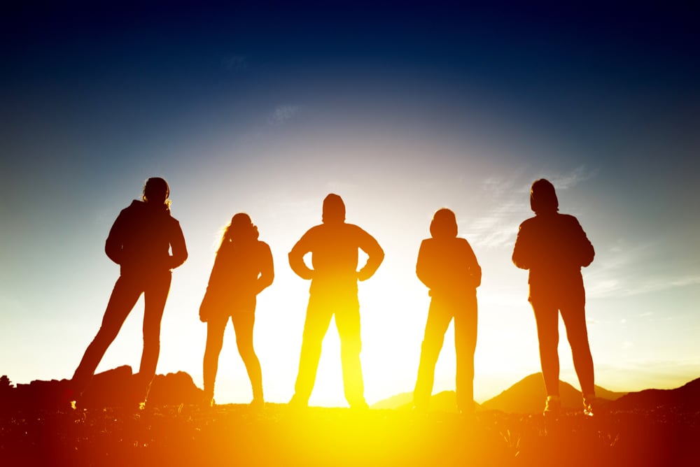 Group of five women silhouettes in sunset light