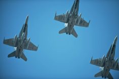 jets fly over during remembrance day in the missing man formation.