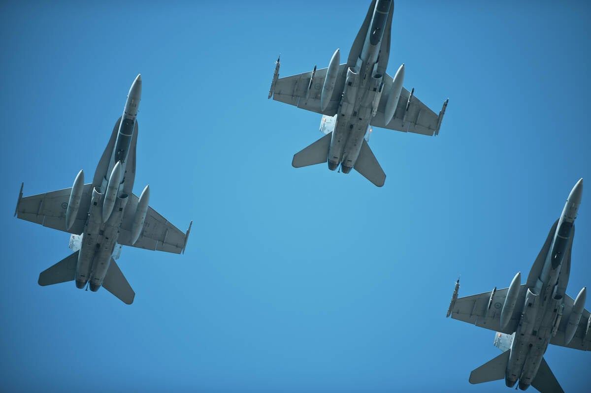 jets fly over during remembrance day in the missing man formation.