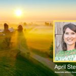 photo of April Stewart with a farm in the background at sunset
