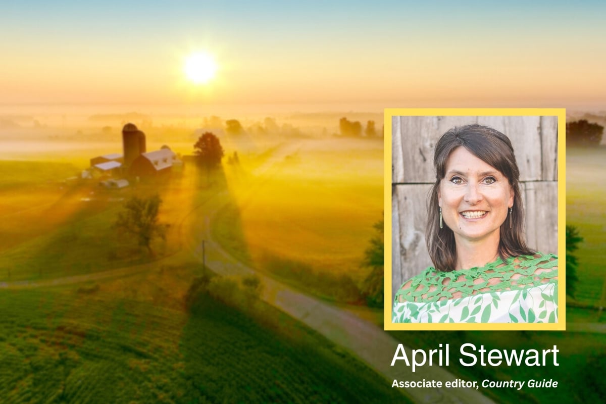 photo of April Stewart with a farm in the background at sunset