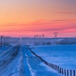 sunrise of prairie with power line in winter, alberta, canada.