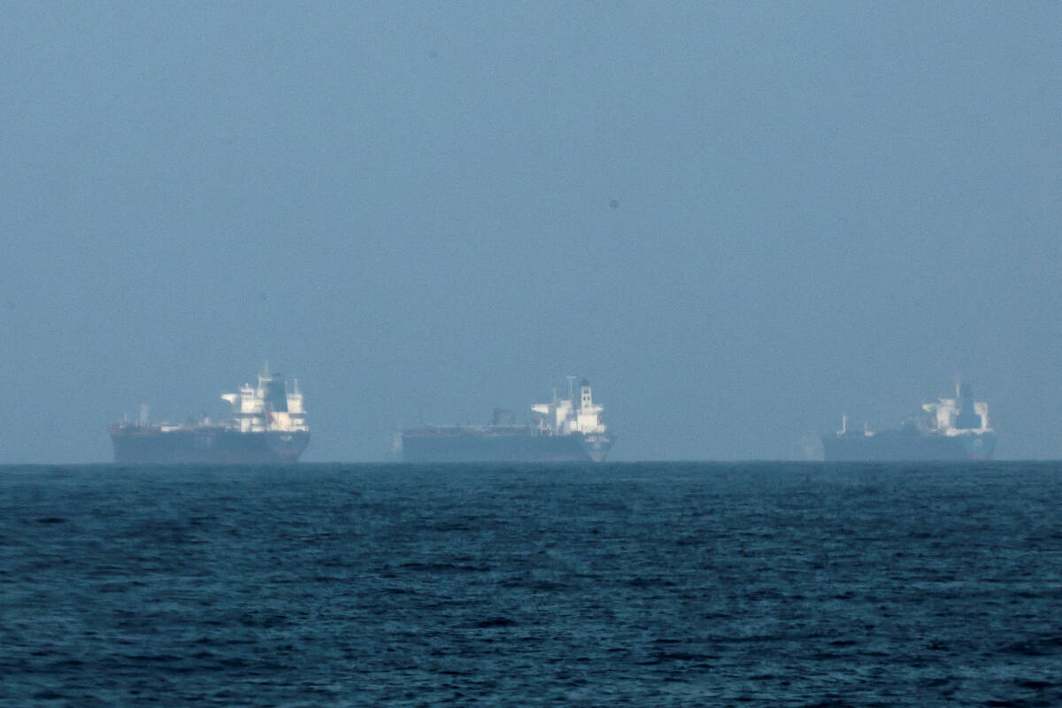 Tankers sit at anchor near the Strait of Hormuz. Disruptions in this vital trade route, combined with export caps in Russia, have severely constrained global supply, forcing Canadian farmers to face significantly higher fertilizer prices just as planting begins. Photo: Reuters/Amr Alfiky/file
