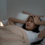 woman in bed having a bad night's sleep