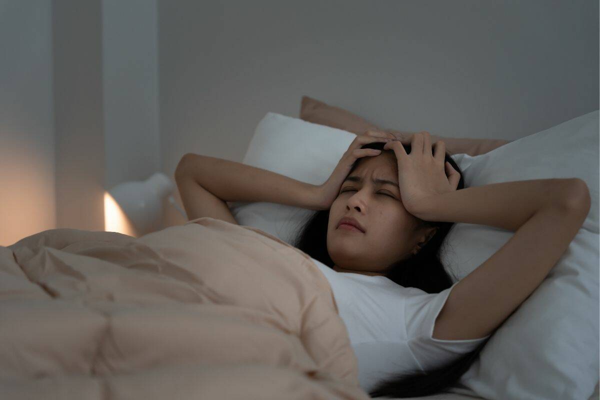 woman in bed having a bad night's sleep